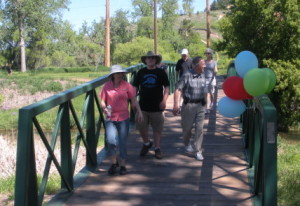 Walkers cross the bridge over Rapid Creek at Mountain View, near the end of Friends' second annual Memory Walk.