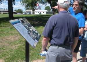 Curtis Price, right, and Del Beck match today's landscape with historic photos on interpretive greenway sign.